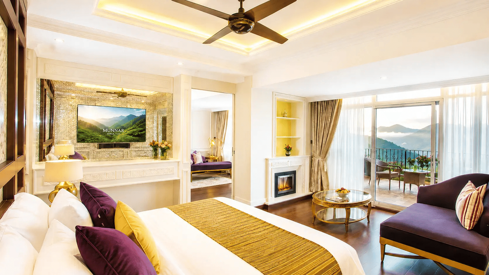 Wild Orchid Suite at Fragrant Nature Munnar with purple and gold decor, fireplace, seating area, and private balcony overlooking the hills