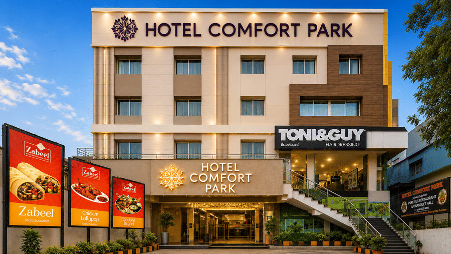 Front exterior of Hotel Comfort Park featuring contemporary architecture, bright signage, and welcoming entrance.