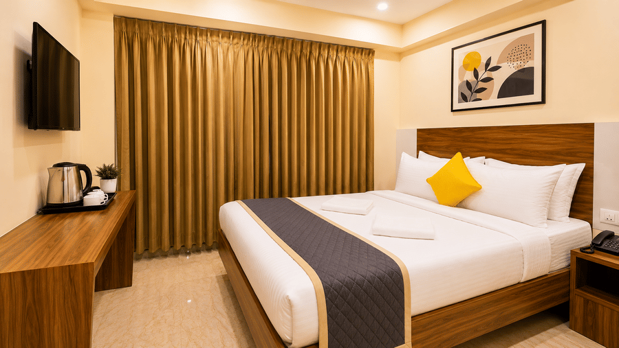 Contemporary guest room at Urban Comforts with elegant interiors, comfortable bedding, and modern in-room amenities