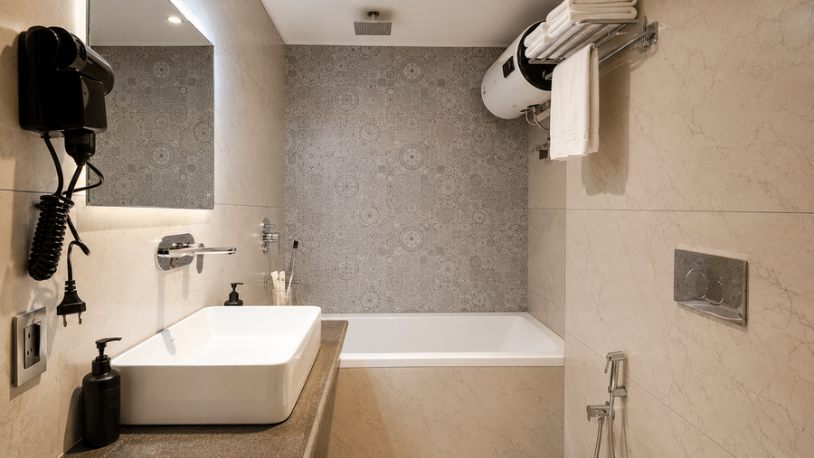 Bathroom featuring a bathtub, counter washbasin, and wall mirror at Valmere Lungta Boutique Hotel & Spa, Darjeeling.