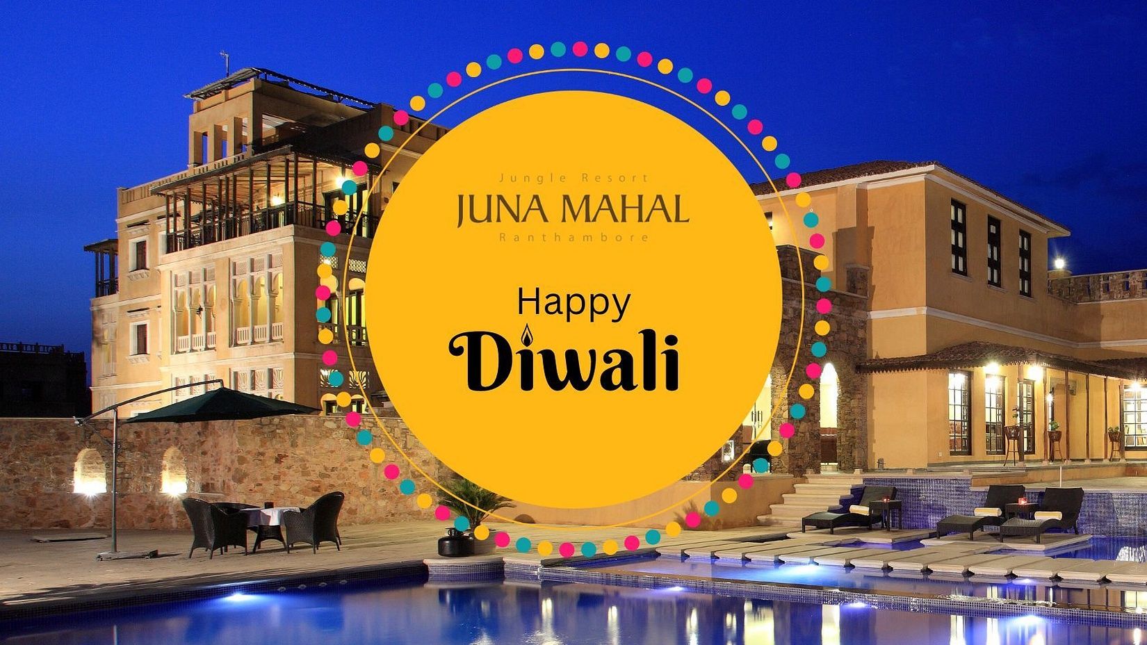 Creative image featuring the facade of Juna Mahal Ranthambore with festive decorations, wishing everyone a Happy Diwali.
