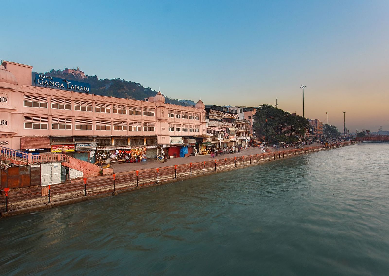 The Ganges River flowing through Haridwar, India, with people bathing and performing rituals.