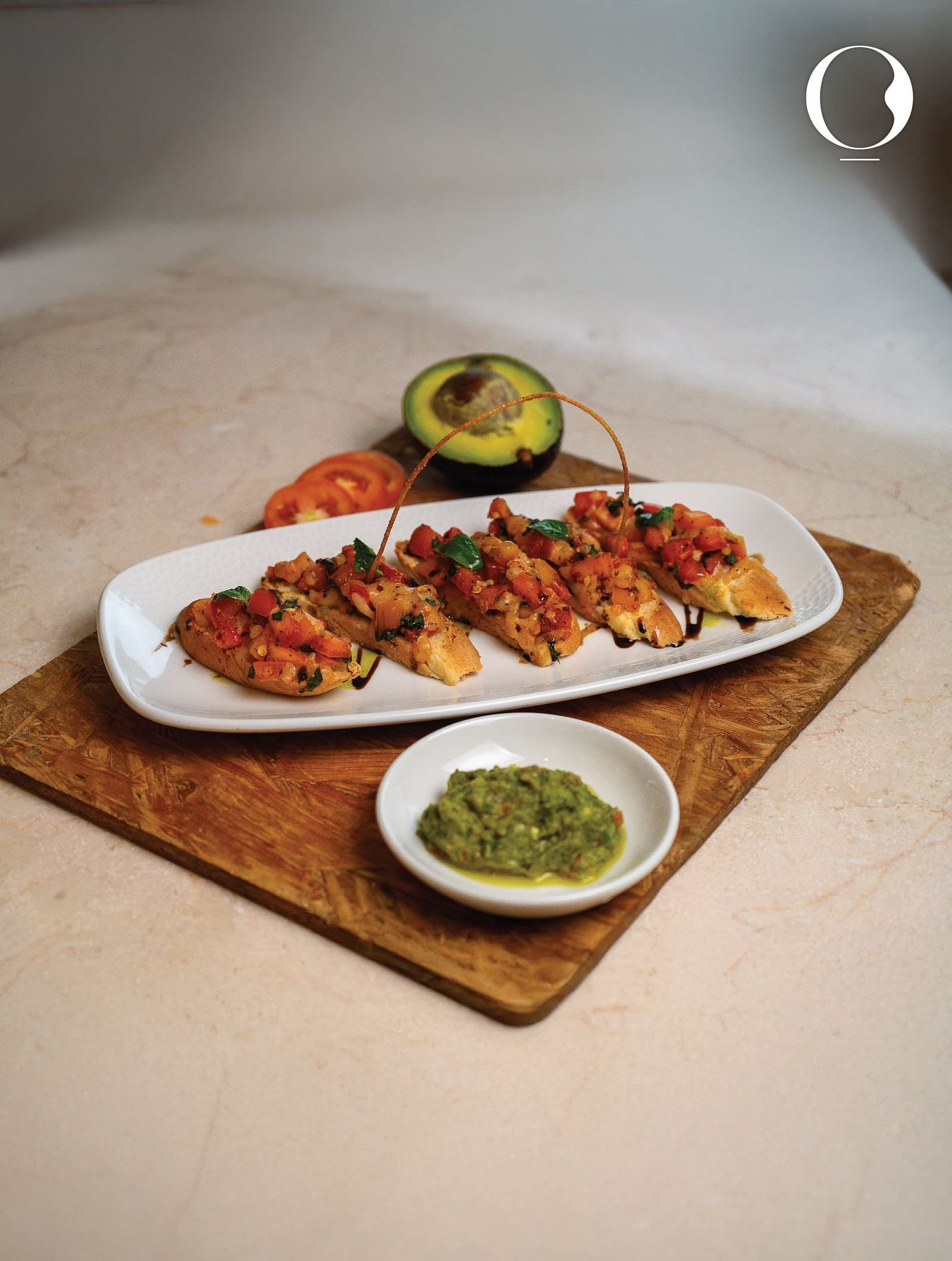 A close up shot of a side dish served on a wooden tray at Miros Hotels with a sip in the side.