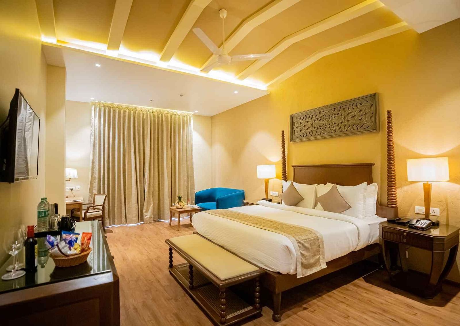 A double bed with side tables and lamps inside one of the rooms - Essentia Luxury Resort & Spa, Udaipur