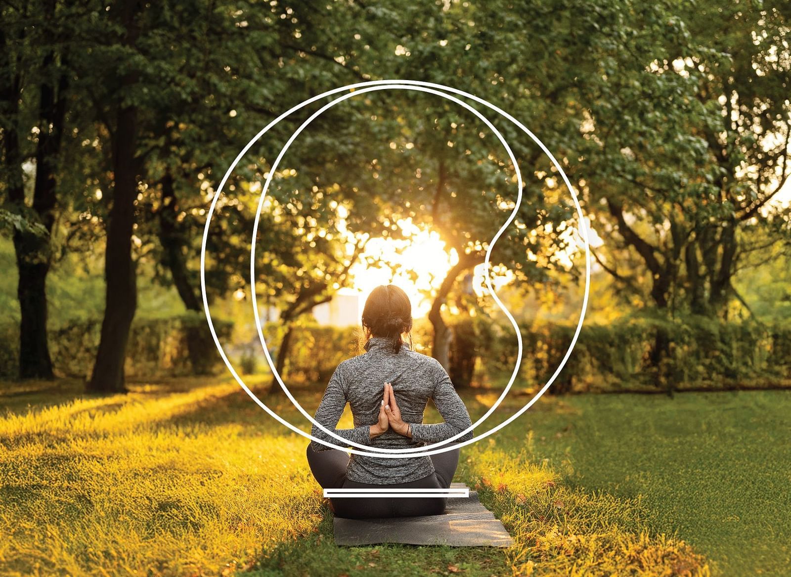 A silhouette of a person sitting in a garden performing yoga and meditation with bright sun rays coming form the canopy.