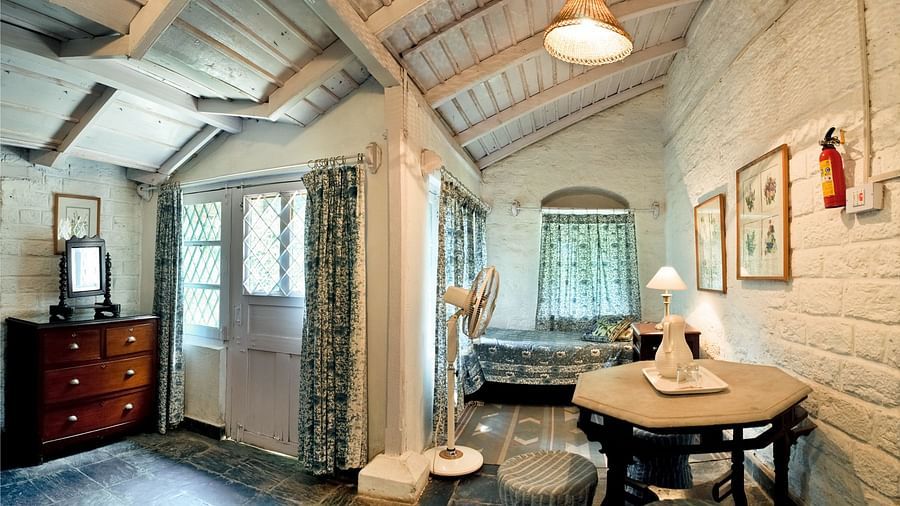 Full view of Butterfly Room with a single bed beside a window - Ramgarh Bungalows, Nainital.