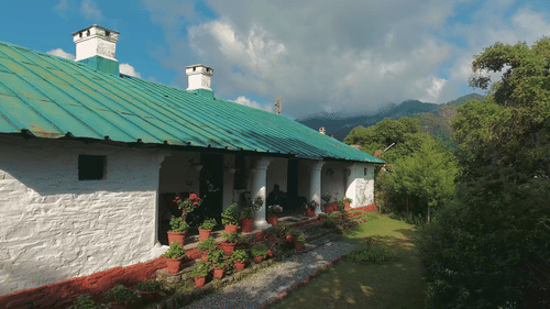 Side view of a bungalow surrounded by trees shot during daytime - Ramgarh Bungalows, Nainital.