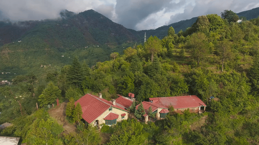 Bird's eye view of the bungalows surrounded by majestic mountains - Ramgarh Bungalows, Nainital.