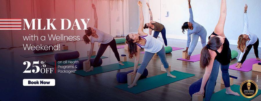 People participating in a group yoga session indoors, promoting a special MLK Day wellness offer with 25% off