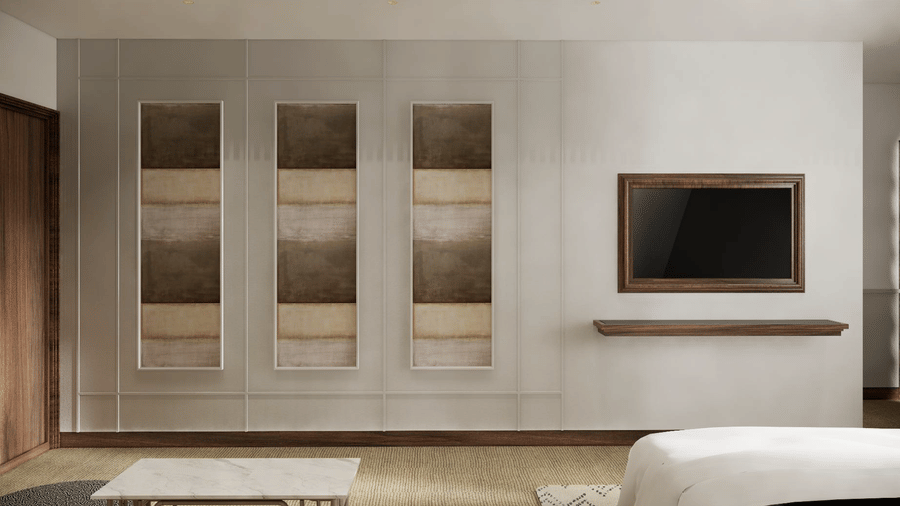Tall, rectangular abstract paintings in neutral tones hanging next to a wall-mounted television on a grey panelled wall at Shilton Suites, Bengaluru.