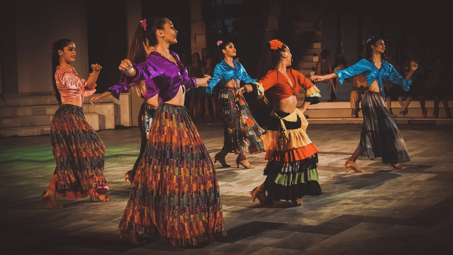 A group of women performing a folk dance at a beach party in Andaman at Symphony Resorts,