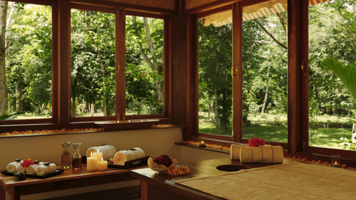 An overview of the interior of Oma Spa with a massage table and other things kept on the table at Barefoot at Havelock.