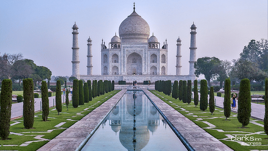 Facade of Taj Mahal featuring pruned trees around it