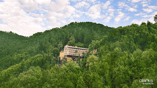 A long shot of JK Clarks Exotica in Dalhousie amidst lush greenery