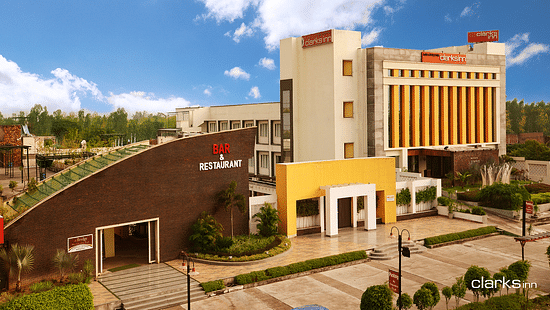 Facade of MB Greens Clarks Inn in Moradabad under blue sky