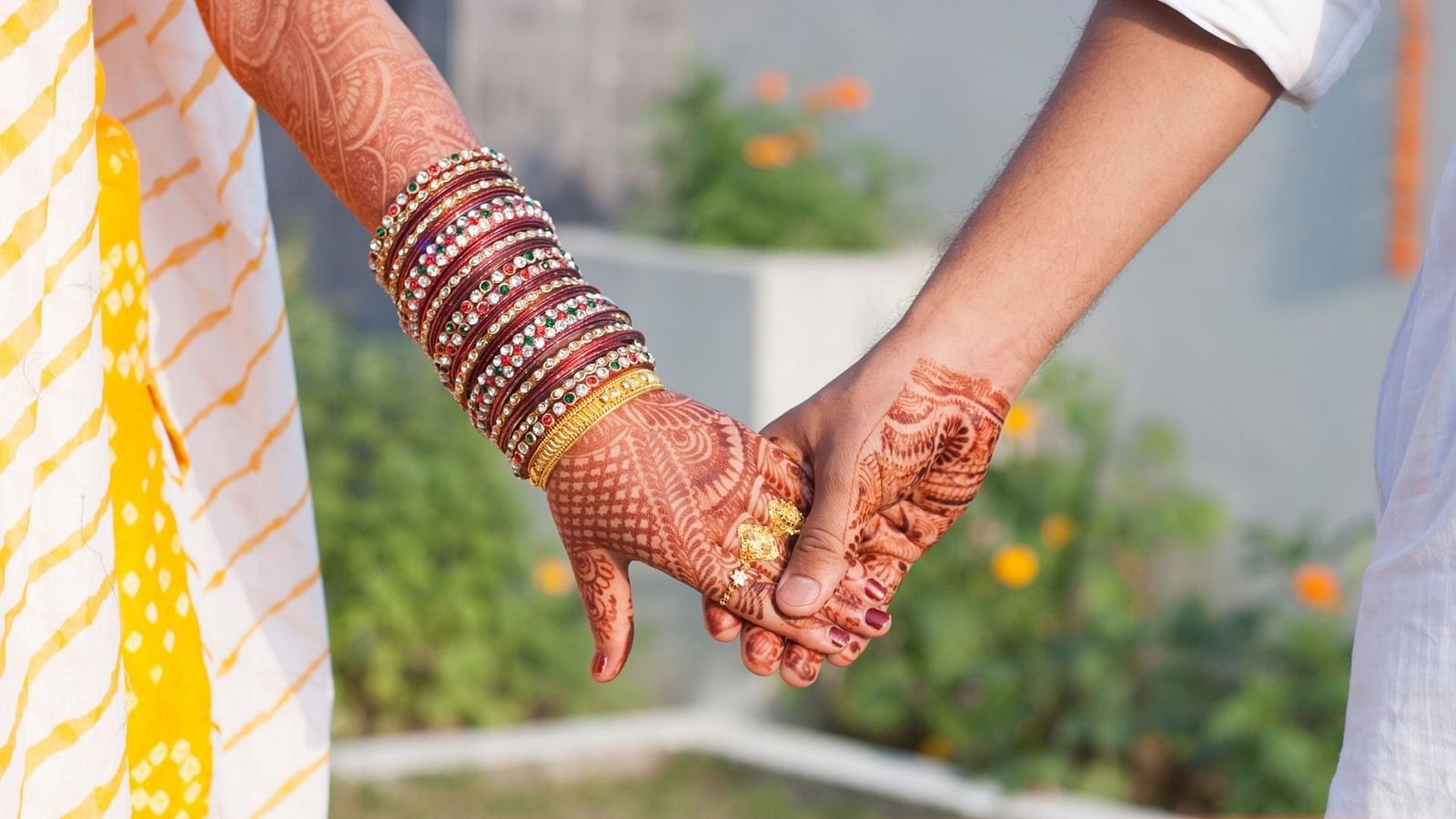 an image of a bride and and groom Holding hands during Wedding