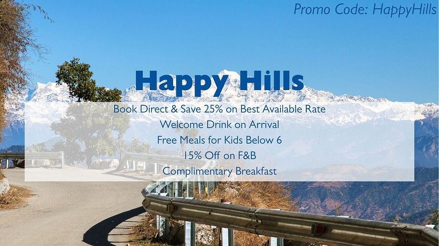 An advertisement for Happy Hills with a background image of a snowy mountain range and a road with a guardrail. The text advertises booking discounts, a welcome drink, free meals for kids, F&B discounts, and complimentary breakfast, and includes a promo co
