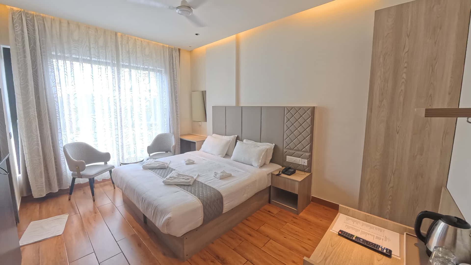 Royal King Room at Hotel Ritvi's Elite with a king bed, armchairs and a wardrobe
