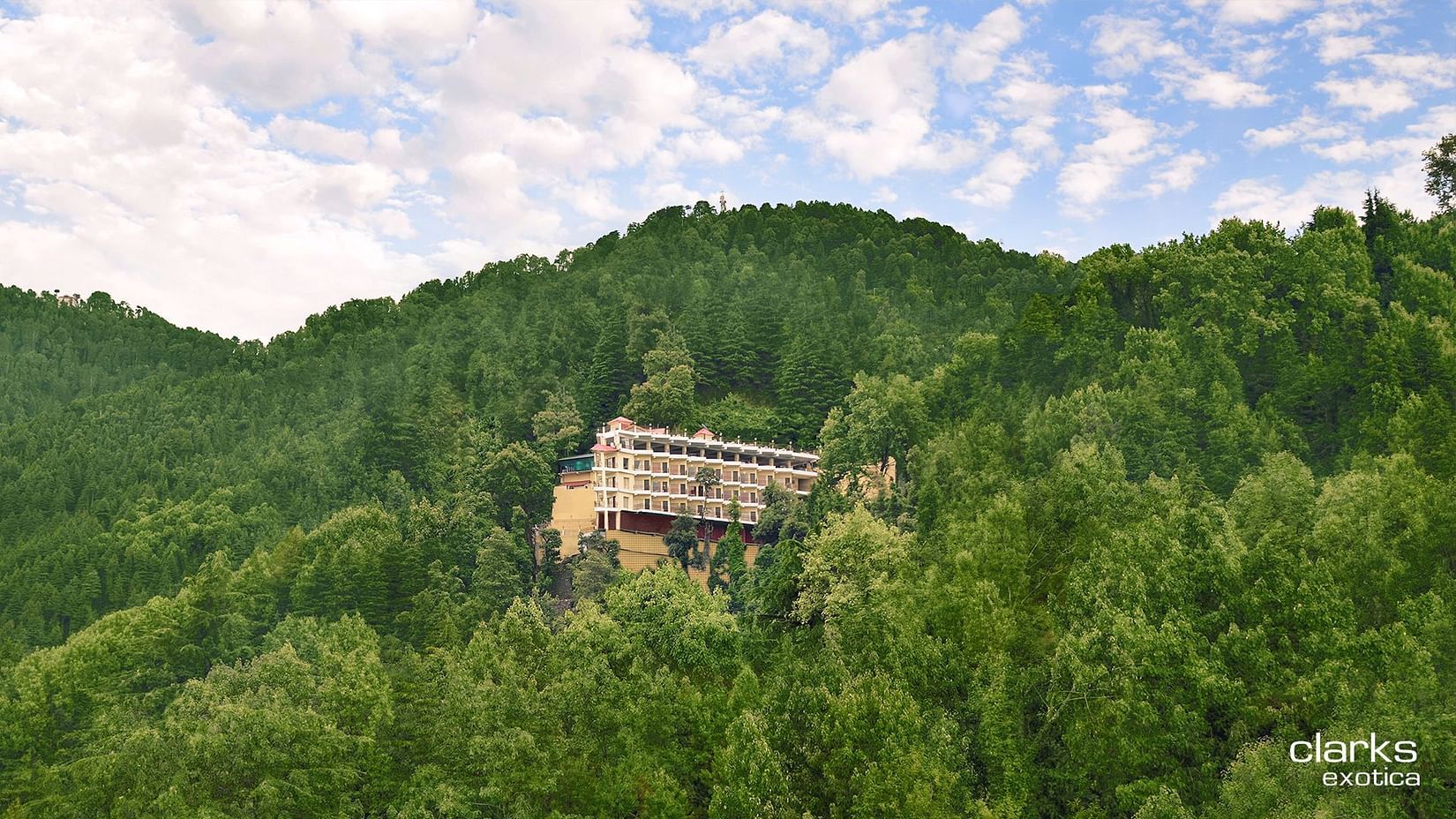A long shot of JK Clarks Exotica in Dalhousie amidst lush greenery