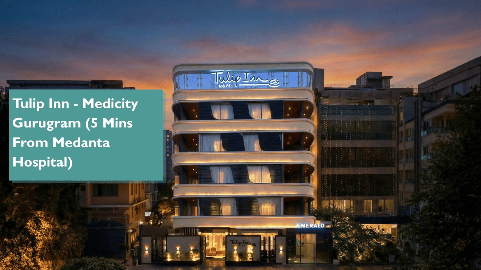 Web banner of Tulip Inn Gurugram featuring the facade of the hotel with illuminated signage under a dark cloudy sky, with a box on one side saying the property is 'Tulip Inn - Medicity Gurugram (5 Mins From Medanta Hospital)'.