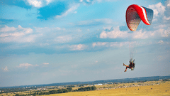 Paramotoring surrounded by green valleys