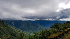Dark rain clouds overlook the hills