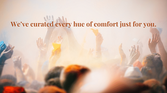 People throwing their colourful hands in the air along with vibrant colours as the text says - We have curated every hue of comfort just for you