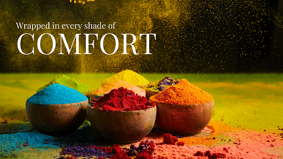 four bowls of colour powders of blue, red, orange and yellow on a vibrant floor as the text on the banner says - Wrapped in every shade of Comfort