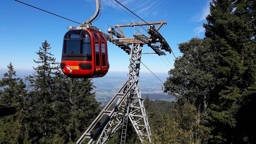 a cable car against the backdrop of a hill station