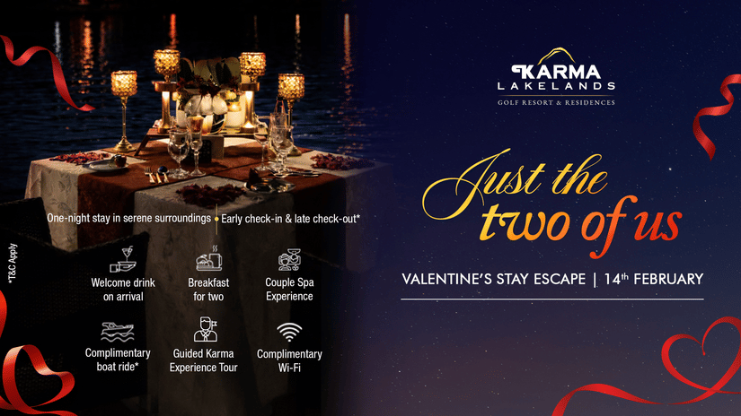 A romantic candlelit dinner setup by the water at Karma Lakelands with a table for 2, featuring flowers, glasses, and candles, promoting the Valentine’s Stay Escape on 14th February with perks including welcome drink, breakfast, couple spa, boat ride, and 