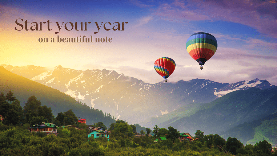 A couple of hot air balloons floating in colourful sky 