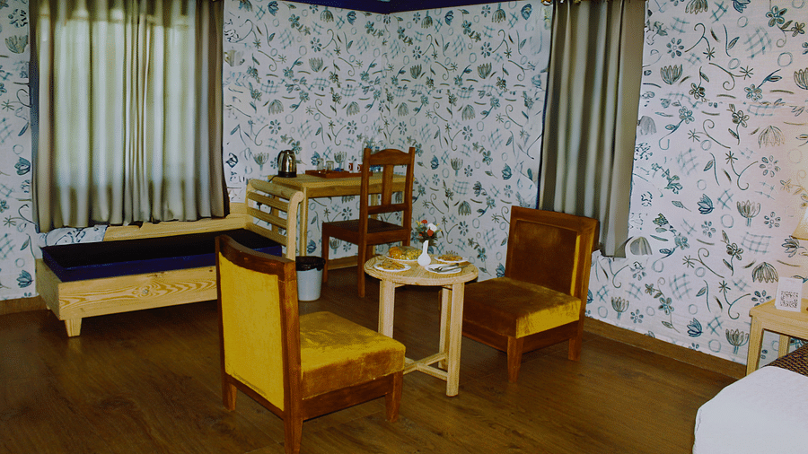 Tea table and 3 chairs and hanged curtains