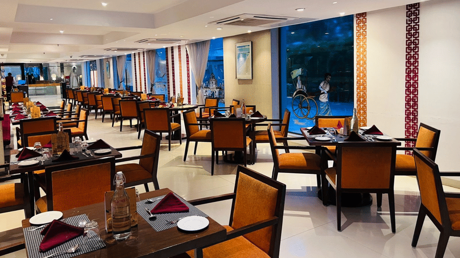 A corner view of the restaurant interior with multiple tables and chairs arranged for guests