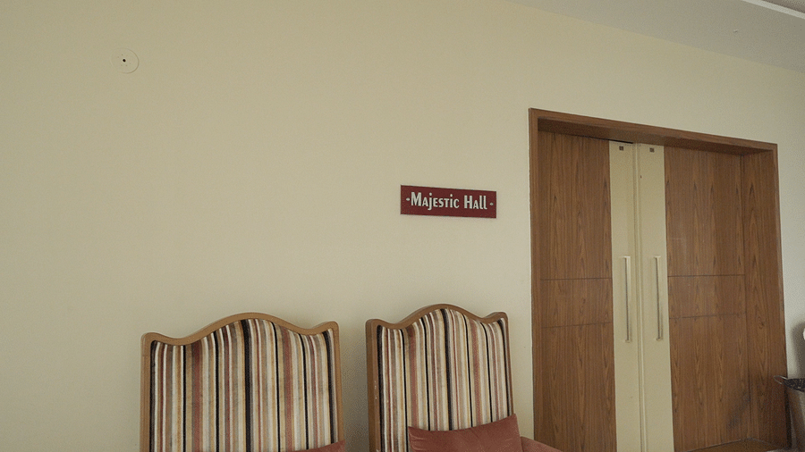 Entrance of Majestic Hall with a name plate and sofas kept outside.