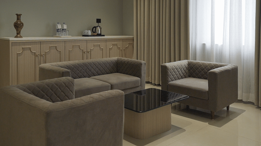 A beautiful couch set with a marble centre table in the suite room - Pride Resort, Rajkot