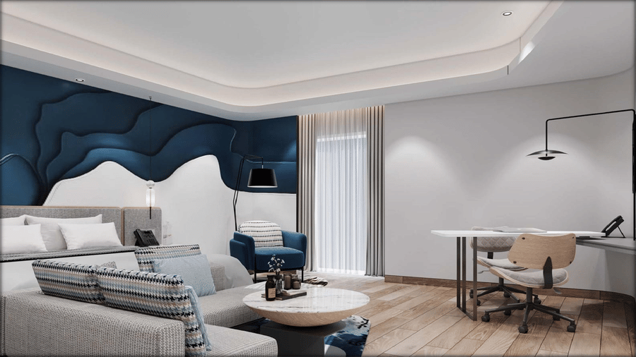 The hotel room with a bed, lounge seating, and a work desk at Riviera Sarovar Portico, Pathankot.