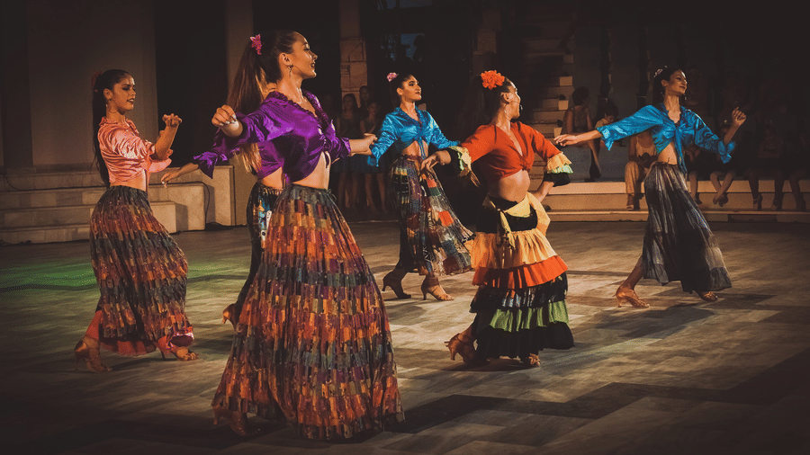 A group of women performing a folk dance at a beach party in Andaman at Symphony Resorts,