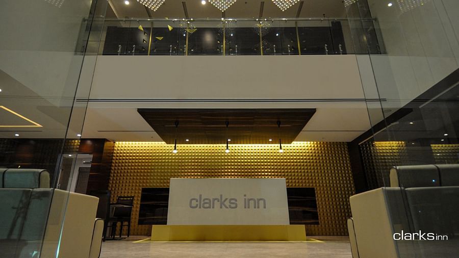 Reception desk under dim lighting along with sitting space on both sides