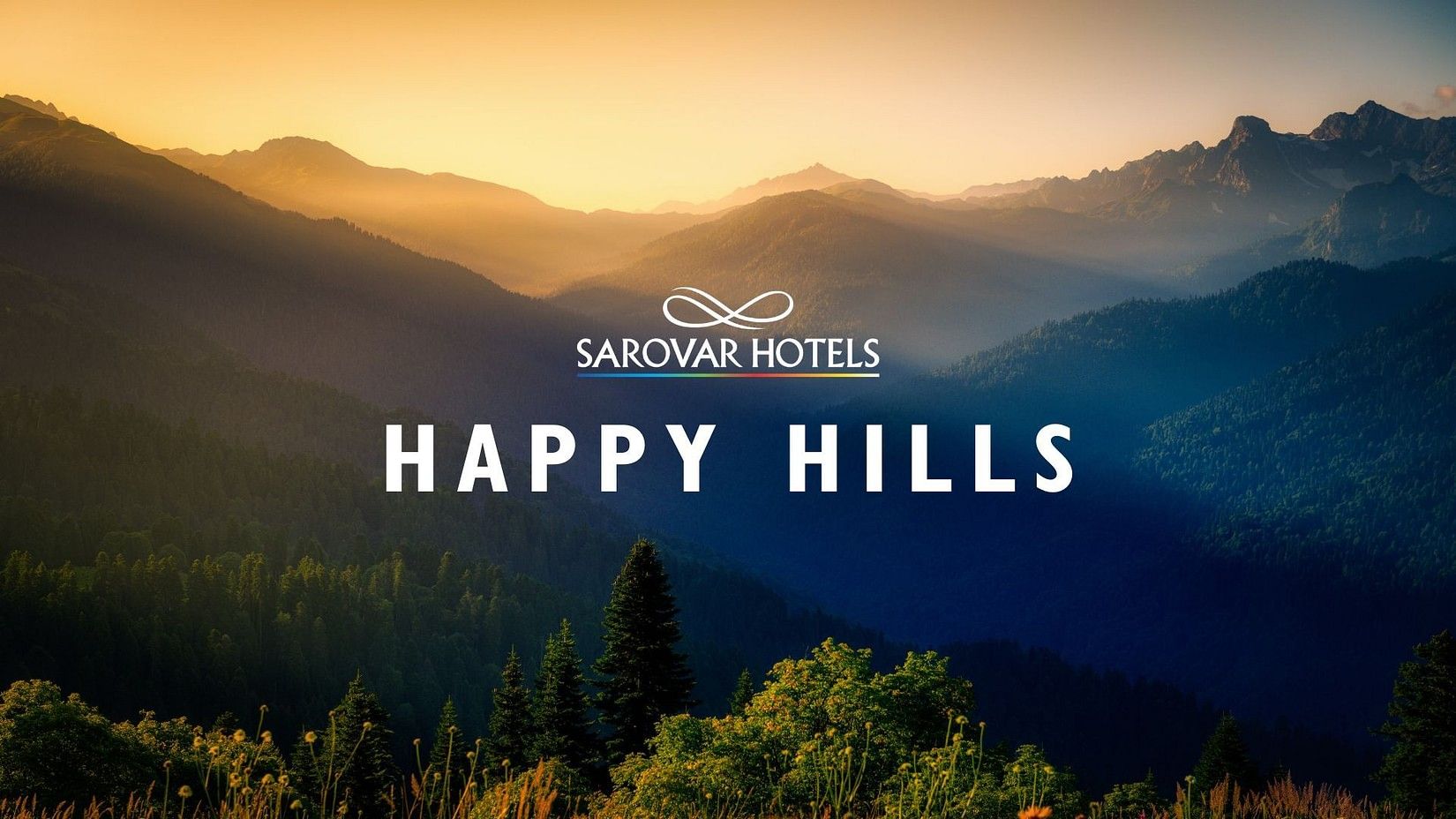 Golden sunset over scenic mountain hills with the text Sarovar Hotels, Happy Hills