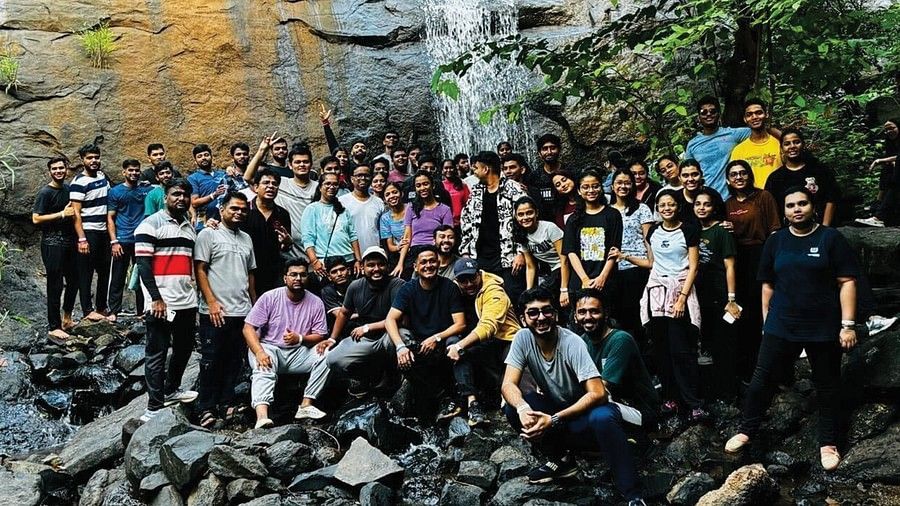 a picture of a corporate team outdoors posing for a photography during daytime