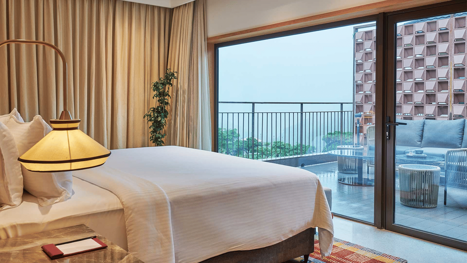 A beautiful room featuring a double bed in one of our luxury rooms with views overlooking the private balcony in front of it.