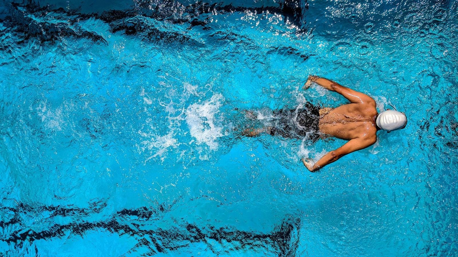 A person swimming in a swimming pool - Rhythm Gurugram
