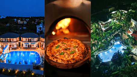 Facade of the resorts with a swimming pools and several plants and trees on either sides with a pizza placed at the center..