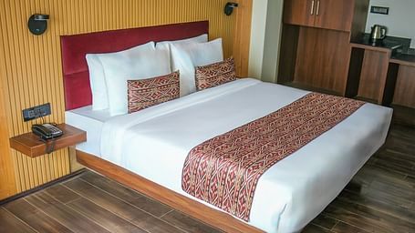 The Standard Room featuring a double bed with a wall mounted bed side shelf - Yashshree Lachen