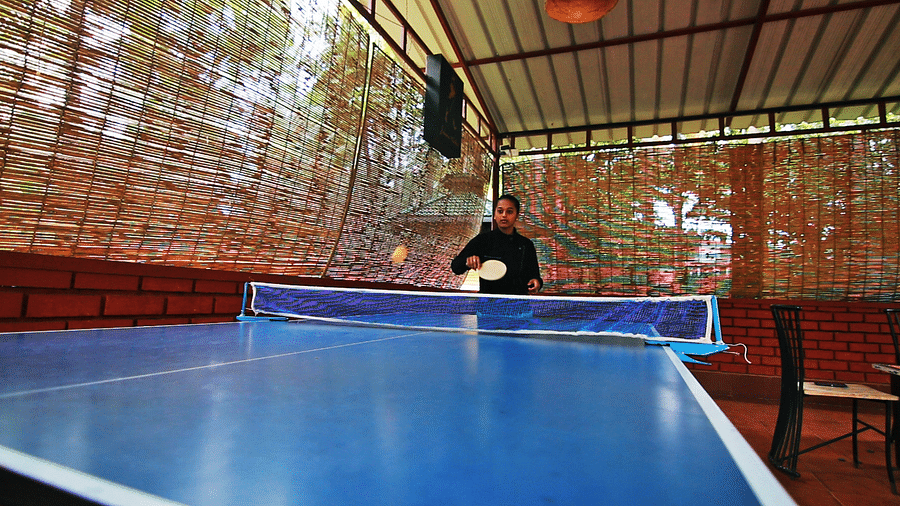 Image of a person playing table tennis at Coorg Jungle Camp Backwater Resort, Kushalnagar.