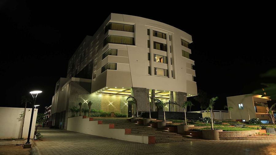 Side view of facade of Dhanalaksmi Srinivasan Hotels, Perambanur well lit at night