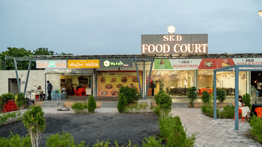 Outdoor food court displays the 'SKD Food Court' signage, providing a spacious area for visitors to dine outdoors.