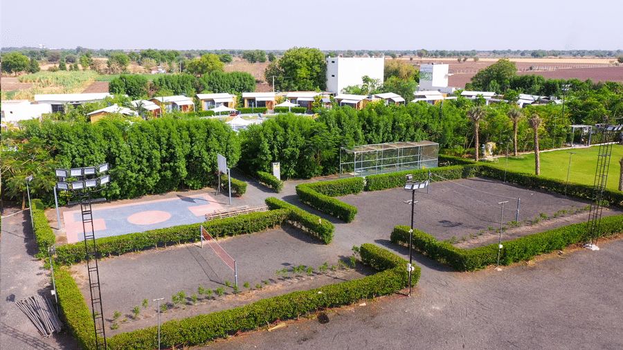 Outdoor sports courts and greenery at Lords SKD Resort, Salangpur.