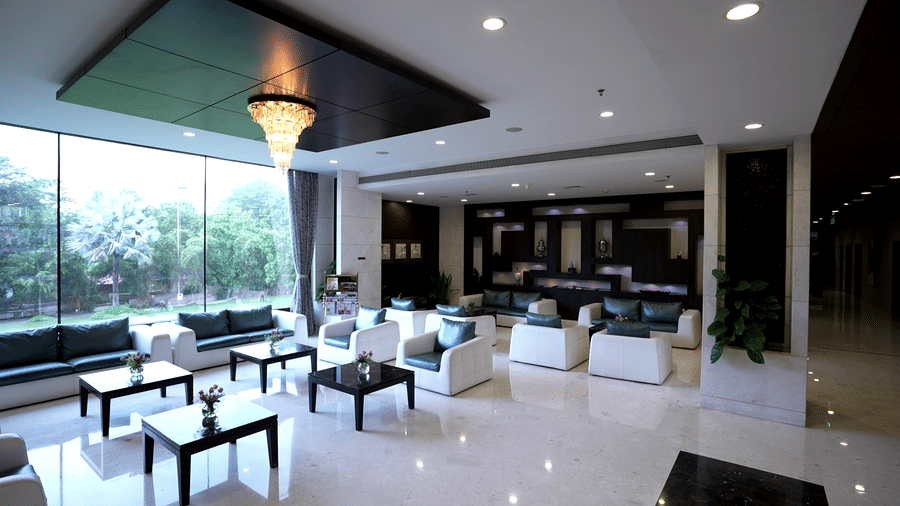 Spacious hotel lobby area with ample of seating apace and natural light coming in at Narayani Heights Hotel & Resorts, Ahmedabad.