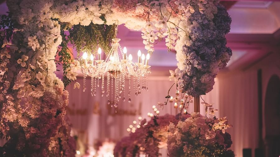 A flowery wedding decoration with a chandelier inside one of the banquet halls at Rhythm Gurugram.
